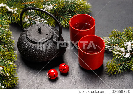 Christmas tea setting with teapot, cups, and fir tree branches Christmas tea setting with teapot, cups, and fir tree branches 132668898