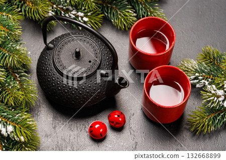 Christmas tea setting with teapot, cups, and fir tree branches Christmas tea setting with teapot, cups, and fir tree branches 132668899