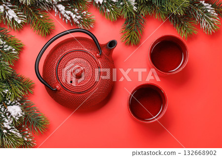 Christmas tea setting with teapot, cups, and fir tree branches Christmas tea setting with teapot, cups, and fir tree branches 132668902
