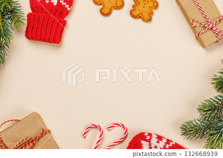 Christmas background with fir branches, gifts and cookies on beige surface 132668939