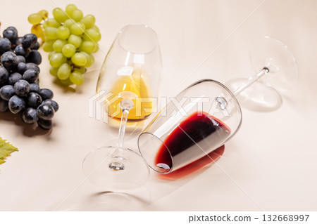 Wine glasses and grapes on beige background 132668997