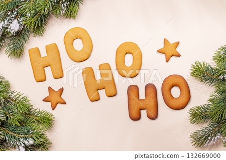Ginger cookies shaped as Ho Ho Ho with fir branches , Christmas card style 132669000