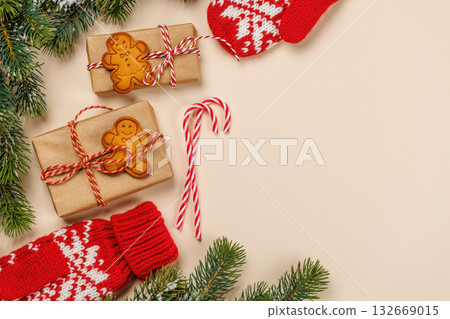 Christmas background with fir branches, gifts and cookies on beige surface 132669015
