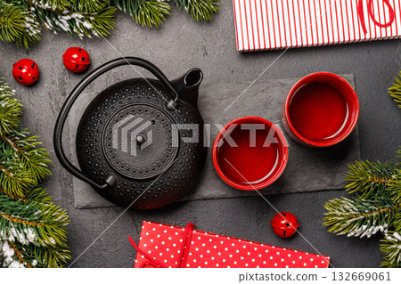Christmas tea setting with teapot, cups, and fir tree branches Christmas tea setting with teapot, cups, and fir tree branches 132669061
