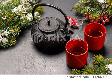 Christmas tea setting with teapot, cups, and fir tree branches Christmas tea setting with teapot, cups, and fir tree branches 132669062