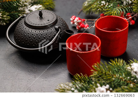 Christmas tea setting with teapot, cups, and fir tree branches Christmas tea setting with teapot, cups, and fir tree branches 132669063