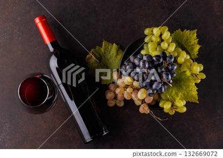 Red wine bottle and fresh grapes 132669072
