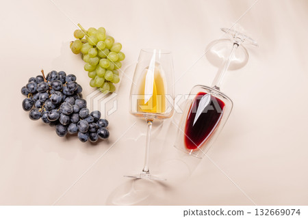 Wine glasses and grapes on beige background 132669074