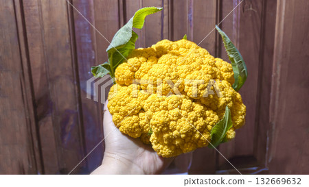 Purple, yellow, and white cauliflower on a supermarket shelf. Ready for sale. Purple, yellow, and white cauliflower on a supermarket shelf. Ready for sale. 132669632