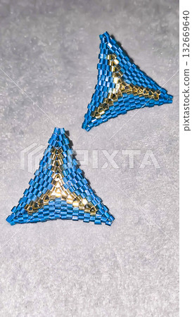 Handmade triangle earrings made of beads and glass beads, blue and gold 132669640