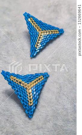 Handmade triangle earrings made of beads and glass beads, blue and gold 132669641