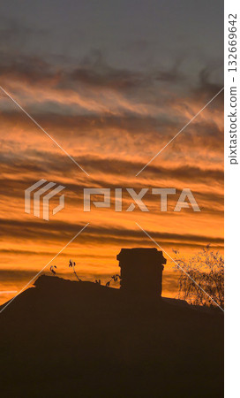 The red-crimson and orange evening sky over the city. Fiery sunset. 132669642
