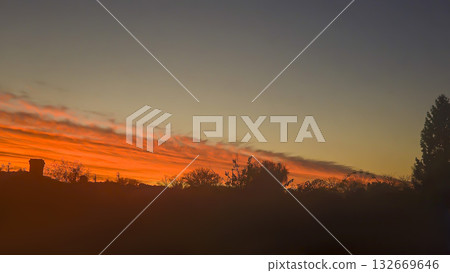 The red-crimson and orange evening sky over the city. Fiery sunset. The red-crimson and orange evening sky over the city. Fiery sunset. 132669646