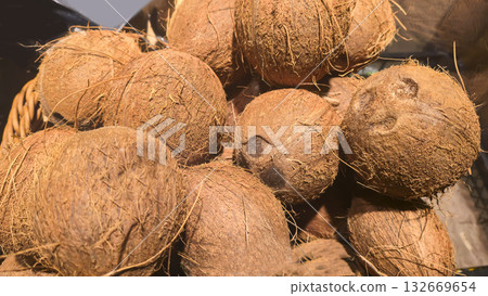 Coconuts in large crates on store shelves at a supermarket, ready for sale. 132669654