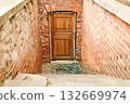 Wooden Basement Door in Red Brick Arched Stairway Entry Wooden Basement Door in Red Brick Arched Stairway Entry 132669974