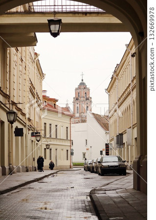 Historic Church Bell Tower Framed by Stone Archway in Old Town 132669978