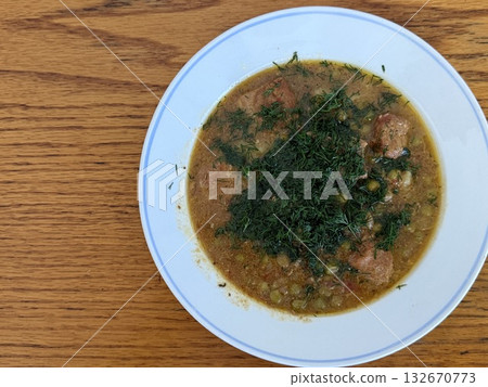 Braised potatoes with green peas, meat, and fresh dill. Braised potatoes with green peas, meat, and fresh dill. 132670773