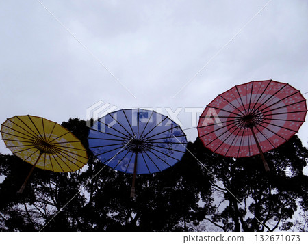 Three-colored open umbrellas floating in the sky Three-colored open umbrellas floating in the sky 132671073