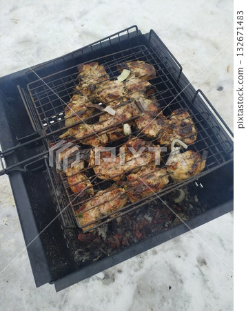 A delicious t-bone steak sizzles on a fiery barbecue grill, perfect for a summer cookout and outdoor dining A delicious t-bone steak sizzles on a fiery barbecue grill, perfect for a summer cookout and outdoor dining 132671483