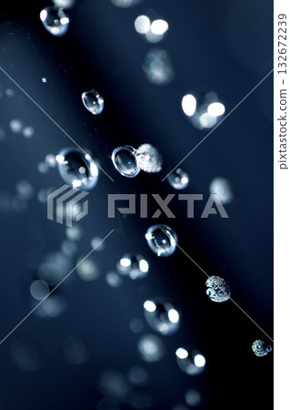 Close up of abstract floating bubbles water droplets condensation rain on a glass transparent bokeh background Close up of abstract floating bubbles water droplets condensation rain on a glass transparent bokeh background 132672239
