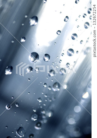 Close up of abstract floating bubbles water droplets condensation rain on a glass transparent bokeh background Close up of abstract floating bubbles water droplets condensation rain on a glass transparent bokeh background 132672254
