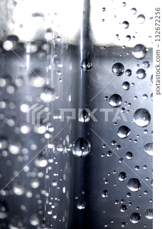 Close up of abstract floating bubbles water droplets condensation rain on a glass transparent bokeh background 132672256