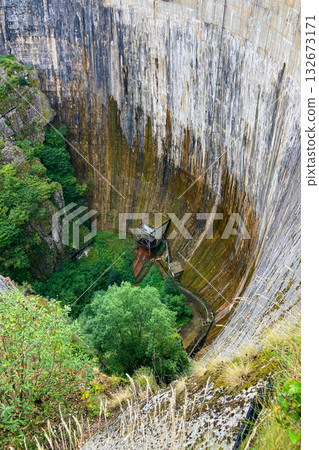 A dam surrounded by mountains and green highlands in Cantabria, Spain. A dam surrounded by mountains and green highlands in Cantabria, Spain. 132673171
