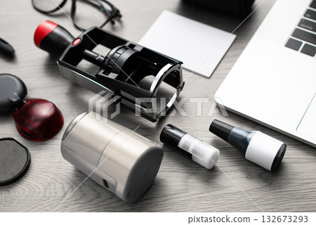 Set of stamps, ink bottles, and laptop on wooden desk 132673293