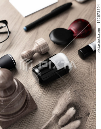 Set of stamps, ink bottles, and laptop on wooden desk 132673294