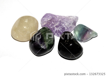 Close up of a healing crystal quartz rock stone on white background Close up of a healing crystal quartz rock stone on white background 132673325