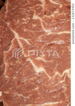 Close up of raw meat steak cut beef on a white background Close up of raw meat steak cut beef on a white background 132673403
