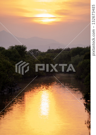 A tranquil golden sunset over the Irumagawa River A tranquil golden sunset over the Irumagawa River 132673485
