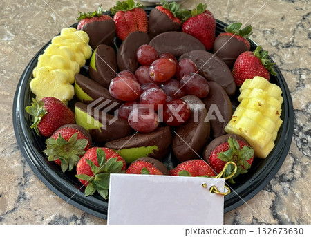 Sweet Platter of Chocolate-Dipped Fruit With a Gift Card on Display Sweet Platter of Chocolate-Dipped Fruit With a Gift Card on Display 132673630