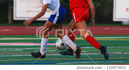 Soccer Players Competing on the Field During an Evening Match 132673632