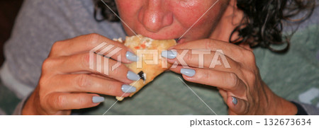 View of a women biting a taco 132673634