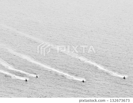 Minimalist Black and White Image of Jet Skis on the Water Leaving White Wake Trails - Abstract Water Sports Activity 132673673