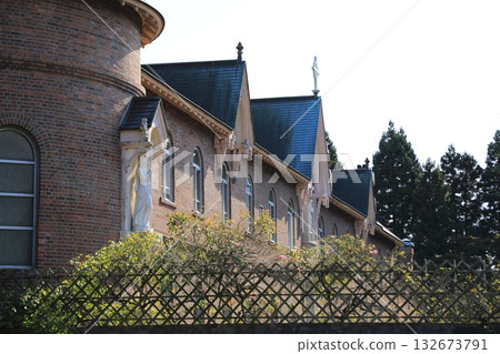 The men-only area of the Trappistine Monastery seen through a red brick wall (Hakodate, Hokkaido, Japan) 132673791