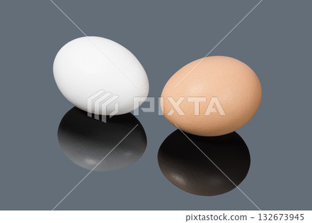 White and brown chicken eggs on gray background 132673945
