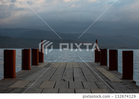 Wooden pier extending into the lake Wooden pier extending into the lake 132674129