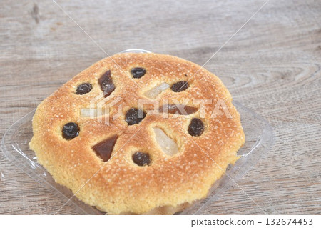castella cake topping raisin and fruit sweet food on plastic tray castella cake topping raisin and fruit sweet food on plastic tray 132674453