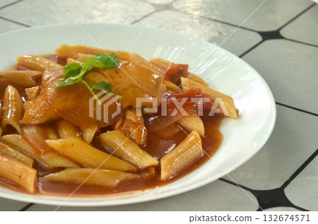 baking penne pasta topping slice chicken in sweet and sour gravy sauce on plate baking penne pasta topping slice chicken in sweet and sour gravy sauce on plate 132674571