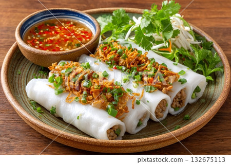 Steamed rice rolls with minced pork and dipping sauce filling a plate Steamed rice rolls with minced pork and dipping sauce filling a plate 132675113
