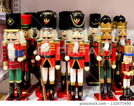 Colorful wooden nutcracker soldiers on store shelf, used for Christmas decoration and holiday interior design. Colorful wooden nutcracker soldiers on store shelf, used for Christmas decoration and holiday interior design. 132675490