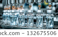 Pharmaceutical automatic production line , conveyor belt with  medical injection glass vials at pharmacy factory. Manufacturing, pharma industry, medicine, automated technology equipment concept 132675506