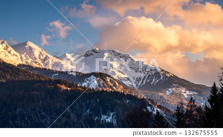 Snowy mountains dyed in the winter morning glow 132675555