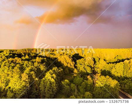 Rainbow over forest area, Poland. Aerial view Rainbow over forest area, Poland. Aerial view 132675736