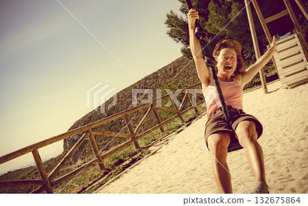 Adult woman having fun on zipline 132675864