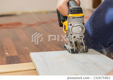 Person cutting floor panels Person cutting floor panels 132675901