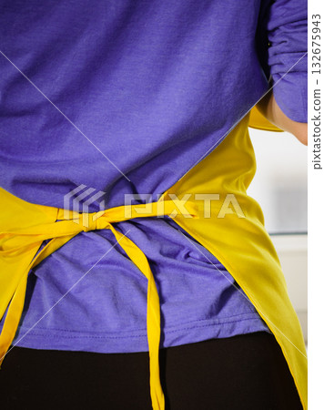 Person wearing yellow apron 132675943
