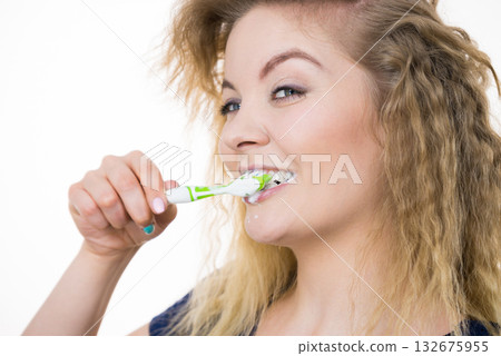 Woman brushing cleaning teeth 132675955